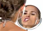 woman looking in mirror compress