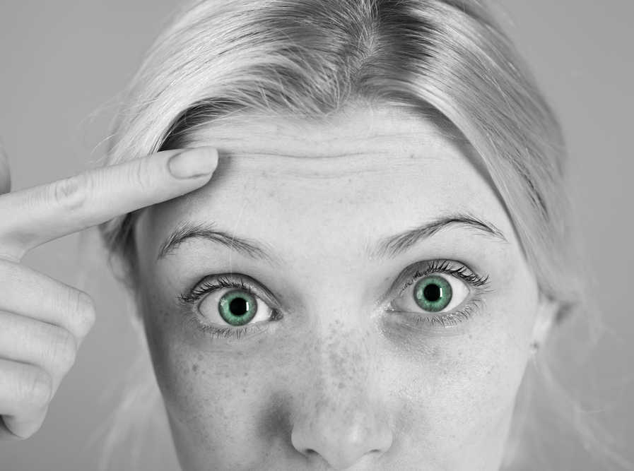 woman pointing forehead