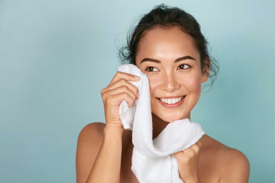 Woman with smooth, glowing skin smiling. What is BBL facial and how can it help your skin.