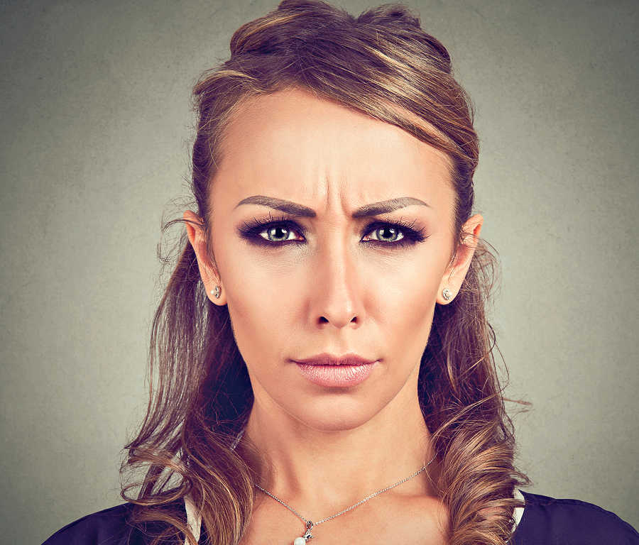 A woman frowning without botox.