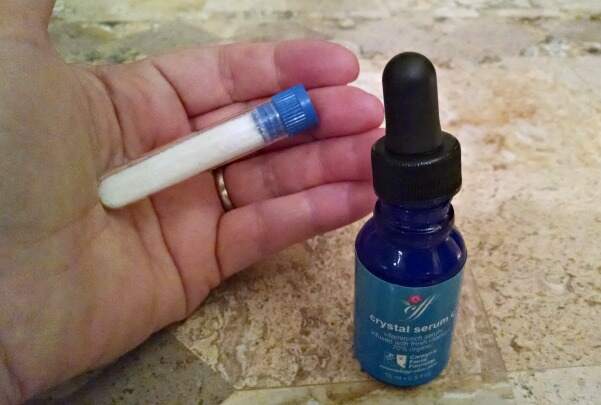 The vitamin C and serum combo Linda used to target age spots and improve skin tone Linda Robison holding the vitamin C powder and serum she used to fade a brown spot on her neck