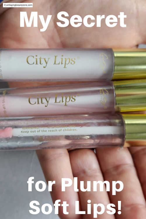 Close-up of three City Lips gloss tubes in hand — hydrating lip glosses that help create plump, soft, and smooth lips.