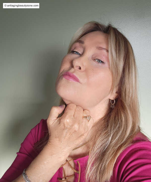 Linda Robison performing a quick morning double chin massage using her knuckles to reduce puffiness and stimulate lymphatic flow.
