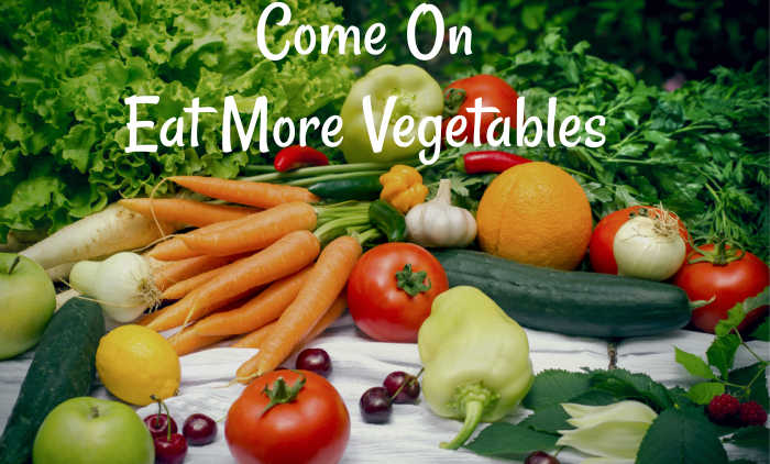Brightly colored vegetables like carrots, bell peppers, and broccoli on a cutting board, promoting healthy skin aging