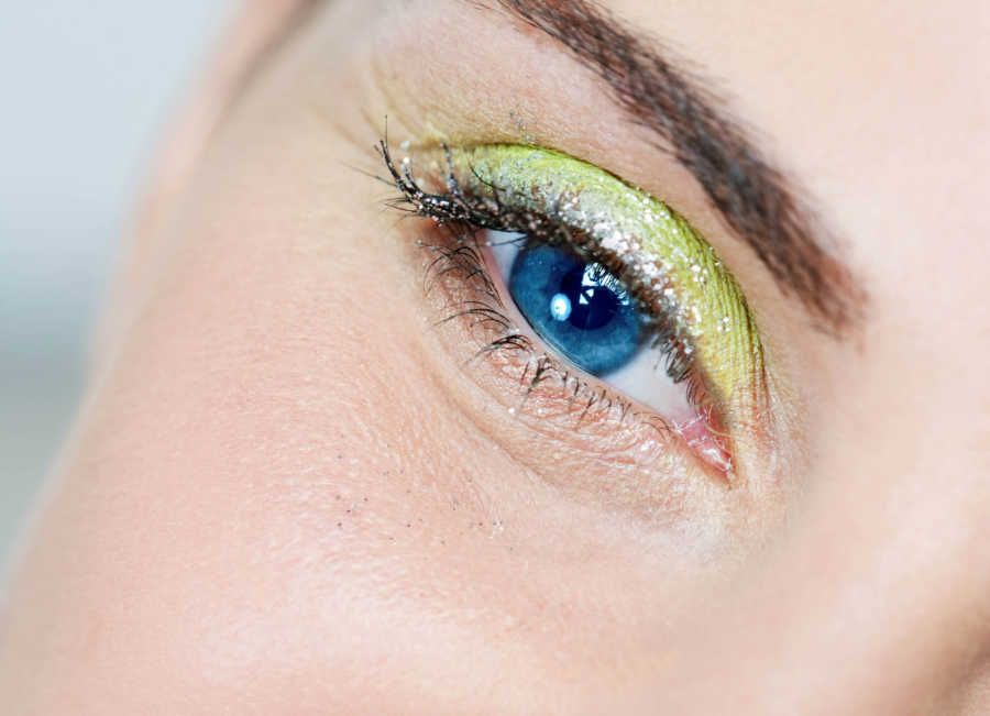 A woman wearing glitter eye makeup. Not a good makeup tip for older women.