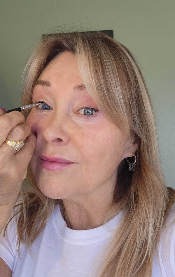 Linda tightlining the full upper waterline with hunter green gel eyeliner for a deeper, yet still soft, defined look.