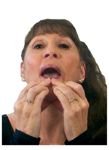 Carolyn from Facial Fitness showing step 2 on how to massage lips for fewer wrinkles.