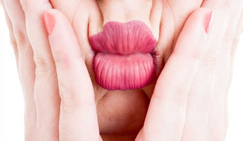 Woman squeezing her mouth, creating lip wrinkles.