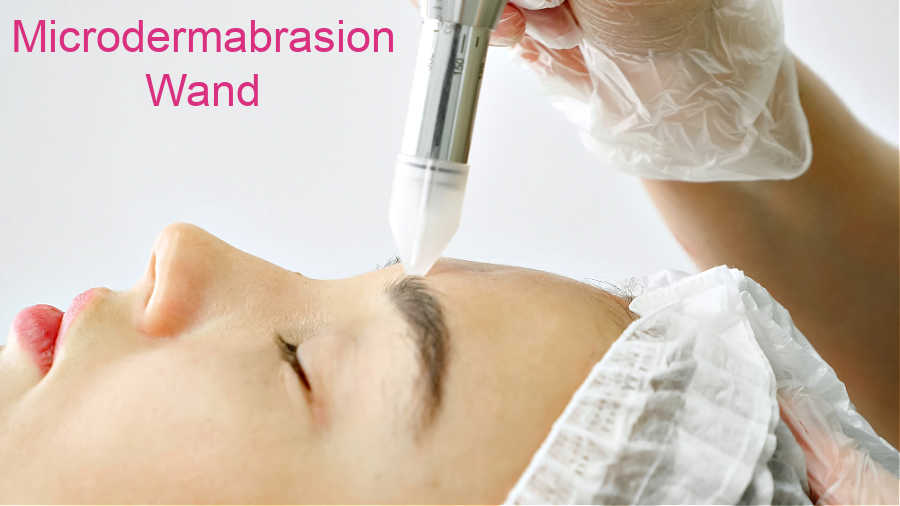 Microdermabrasion wand across the forehead.
