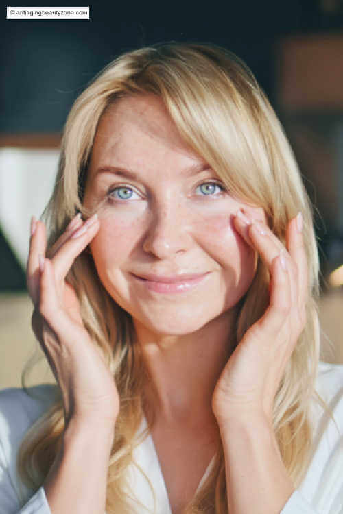 Quick lymphatic massage to reduce puffy eyes fast Woman gently massaging under-eye area to reduce puffy eyes—quick lymphatic sweep