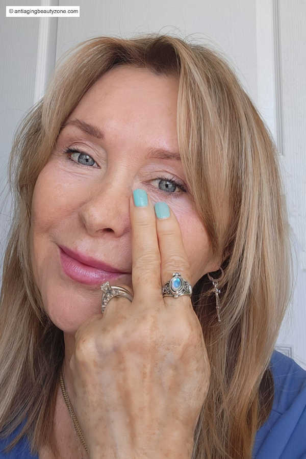 two finger tapping under eye technique to reduce puffy eyes by stimulating circulation along the orbital bone