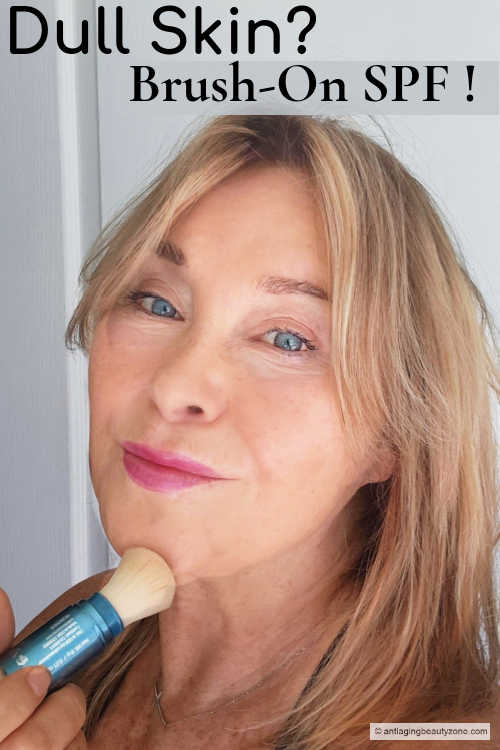 Woman applying brush-on mineral sunscreen to her face, showing a mess-free way to protect skin from aging UV rays.