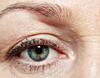 Uneven eyeliner on wrinkled, hooded upper eyelids—close-up showing common issues with mature skin