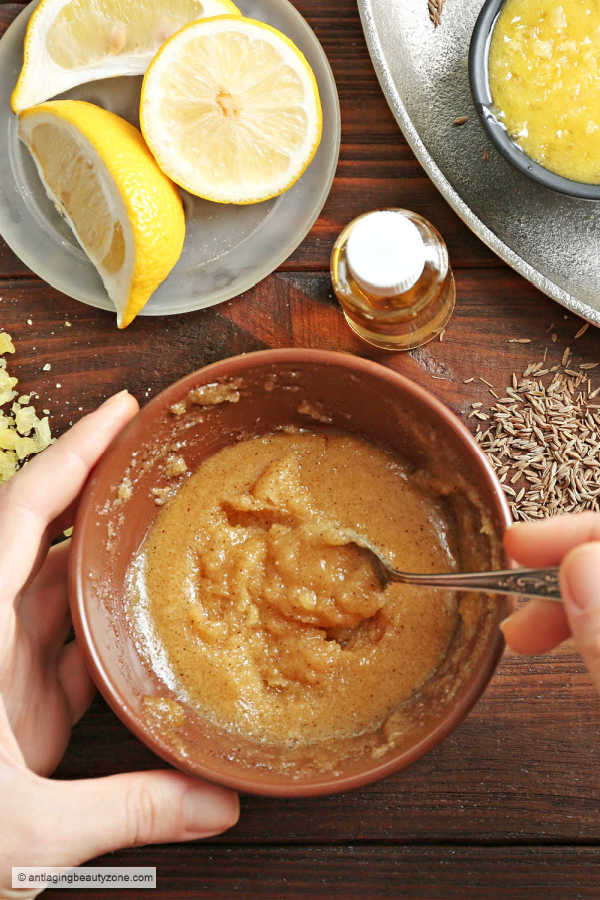 Soothing benefits of turmeric mask using natural skin care remedies and ingredients found at home. Turmeric face mask DIY mixed in a brown bowl.