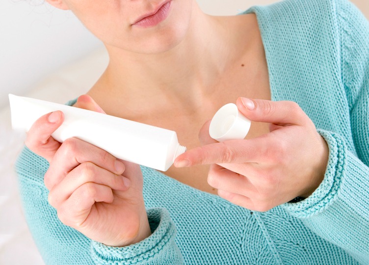 Benefits of fatty acids in skincare. Woman hold a tube of fatty acid cream.
