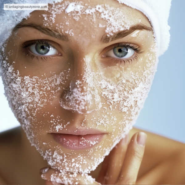 What helps with dull skin? 12 tips for a brighter complexion. A woman exfoliating her dull skin with a sugar scrub.