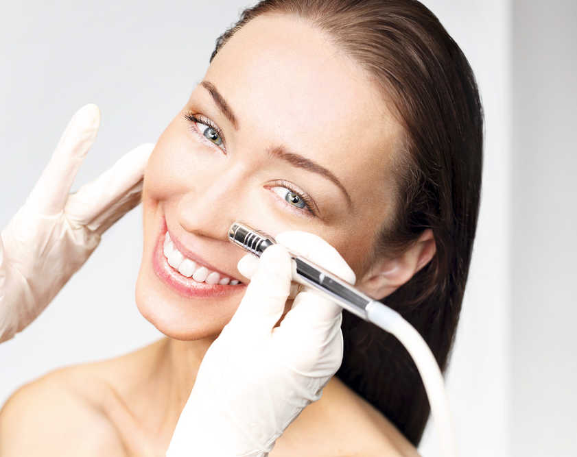 Dermaplaning vs microdermabrasion, which is better and what's the difference between the two? Woman getting microdermabrasion. Dermaplaning vs microdermabrasion.