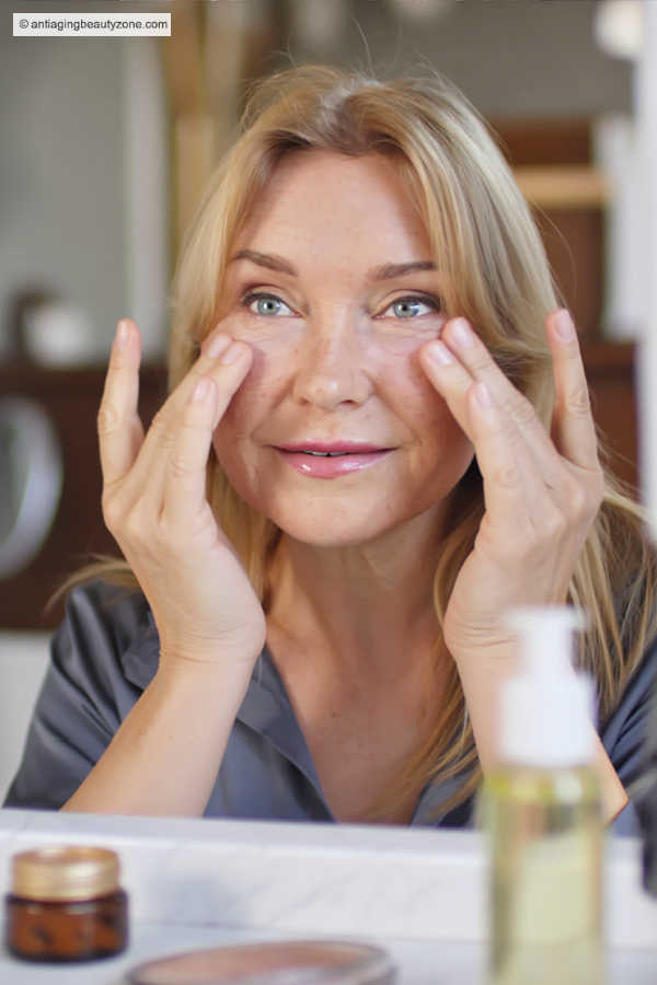 Eye massage and exercises for under-eye wrinkles Woman gently massaging under-eye area to help reduce wrinkles and tired-looking eyes