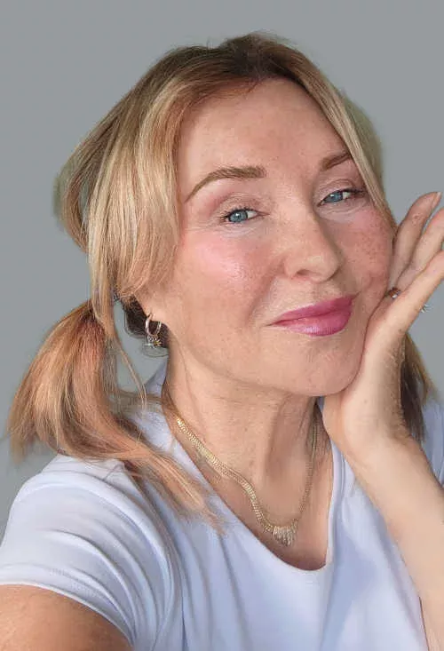 Linda Robison, Certified Facial Fitness Specialist at Anti-Aging Beauty Zone, demonstrating a cheek-lifting massage for naturally firm, youthful skin.
